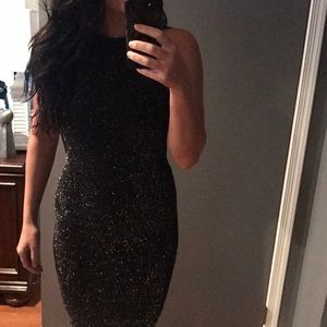 Sleeveless black glitter dress. Only worn once !